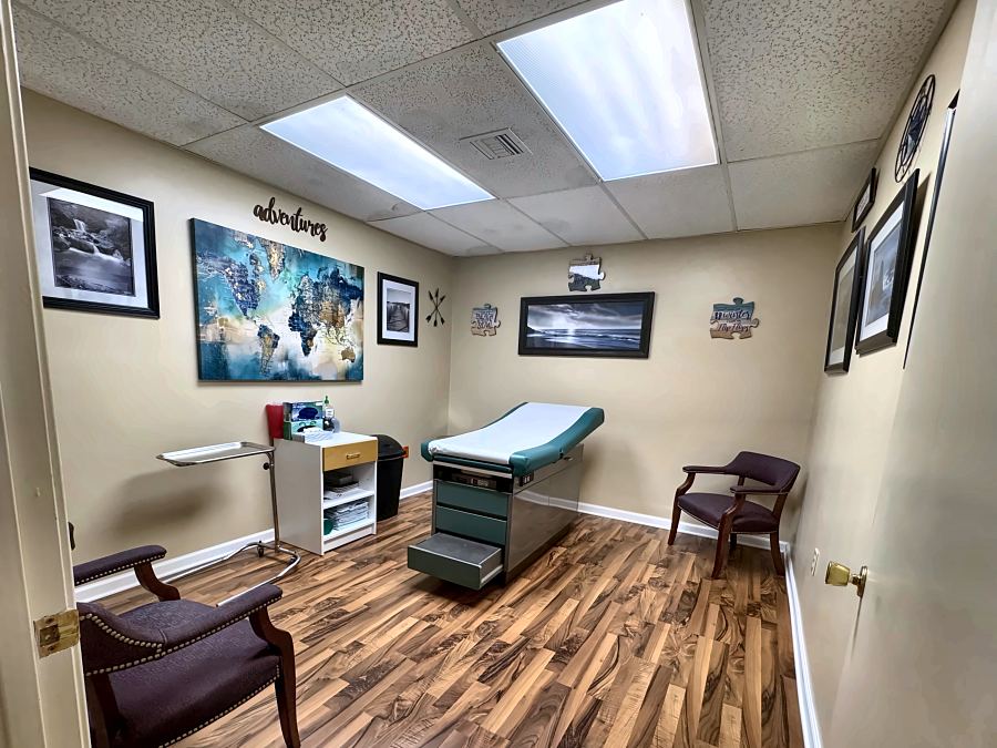 An ExpressMED exam room with a world map on the wall