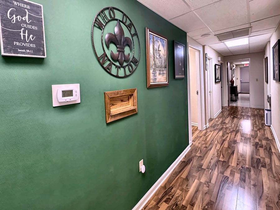 The green hallway at ExpressMED with a fleur de lis sign