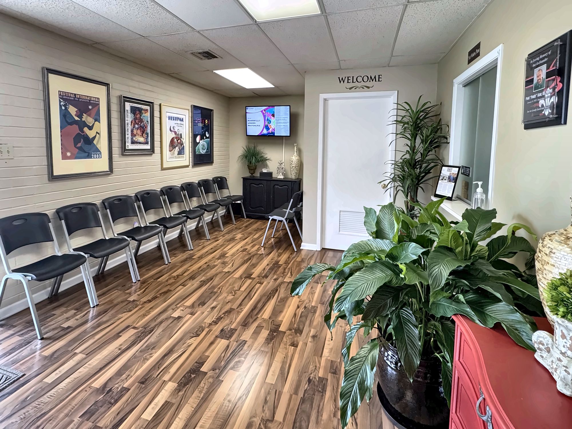 The bright ExpressMED waiting room with wood floors and a welcome sign